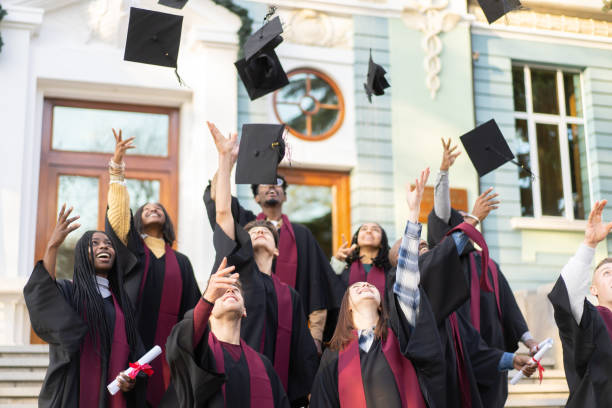 Students celebrating every moment of a graduation ceremony stock photo