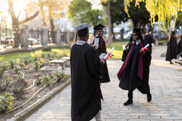 istock Three happy graduates with their diplomas on their way home 1498125240