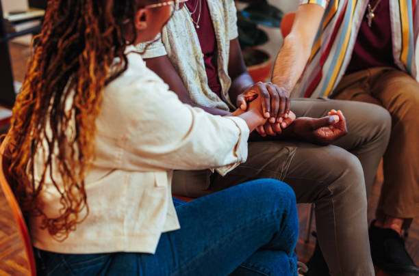 istock African-American young people holding hands while having therapy session 1498125324