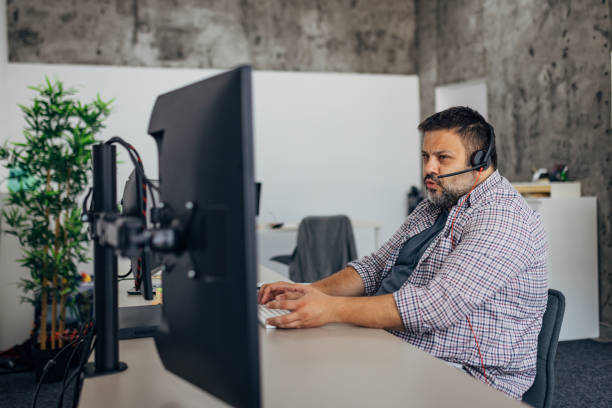 istock Male IT expert makes a phone call with a client 1498126483