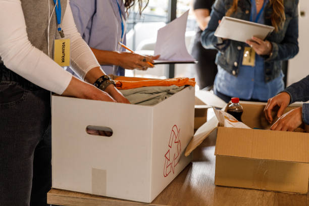 istock Group of female volunteers sorting out boxes with donations 1498126820