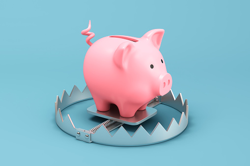 Piggy bank on a metallic trap
