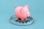 Piggy bank on a metallic trap