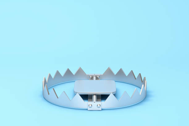 metal bear trap on blue background - confinamento imagens e fotografias de stock