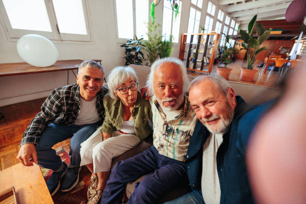 istock Four senior people sitting together on couch 1498129271
