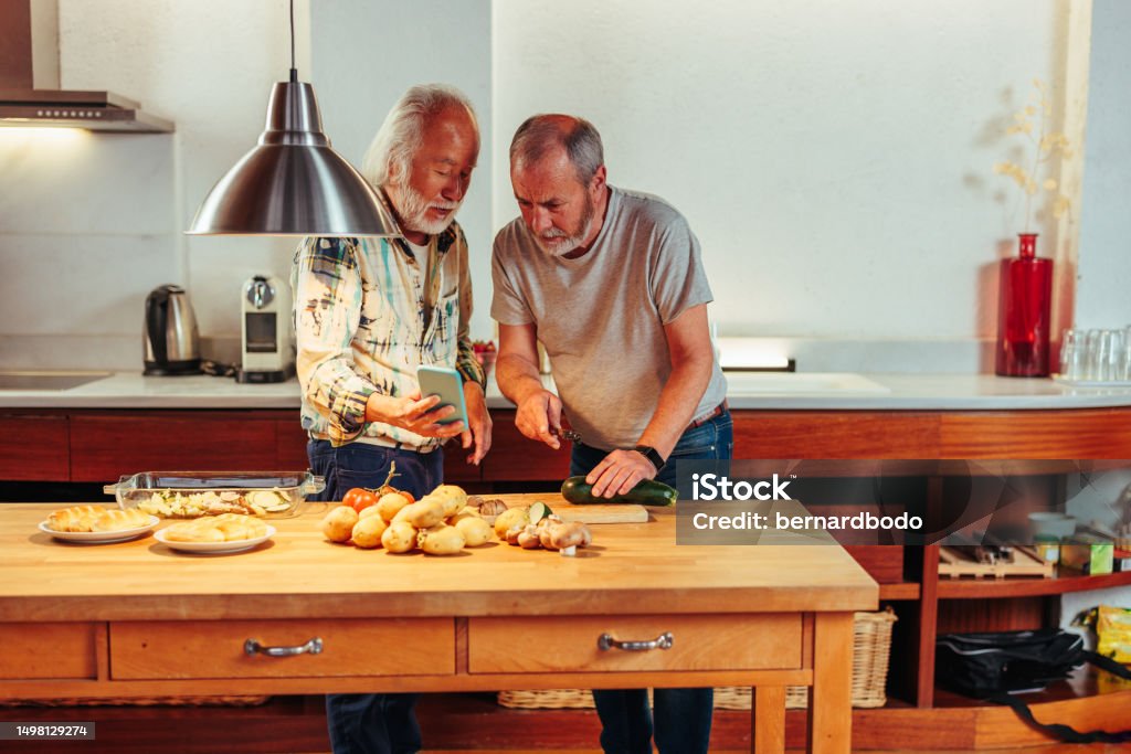 Man Using Man Cooking Two Senior Men Using Kitchen Together Stock Photo - Download Image Now ...