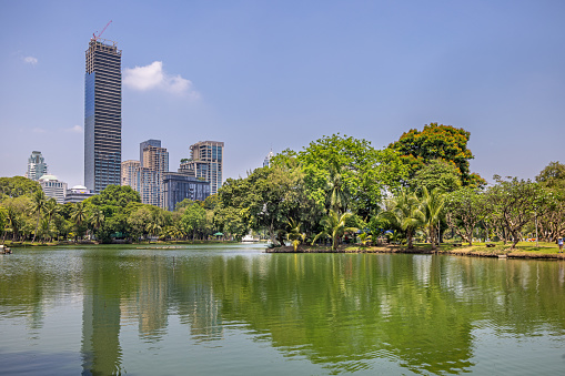 Panoramic view of Kuala Lumpur city waterfront skyline with reflections and beautiful morning sky, Titiwangsa Park, Malaysia. Big size