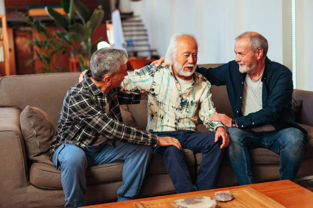 istock Three senior man bonding on sofa in living room. 1498129759