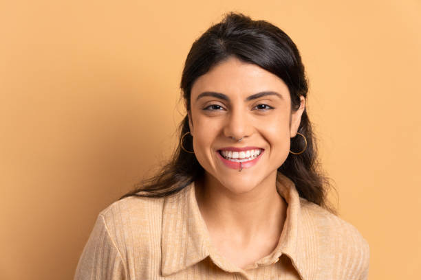 istock woman laughing happily in beige studio 1498129971