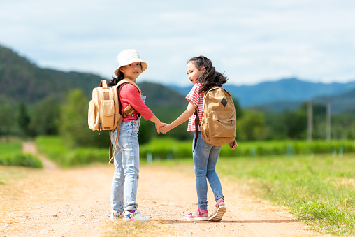 Group friend children travel nature summer trips.  Family Asia people tourism walking on road happy and fun explore adventure outdoors for leisure and destination, mountain background. Travel Lifestyle Concept