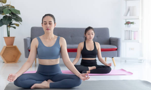 istock women doing yoga 1498132130