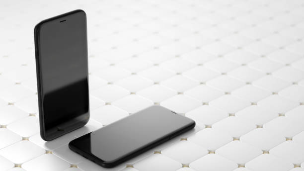 istock Two black smartphones with a blank black screen on the abstract white tile floor 1498133435