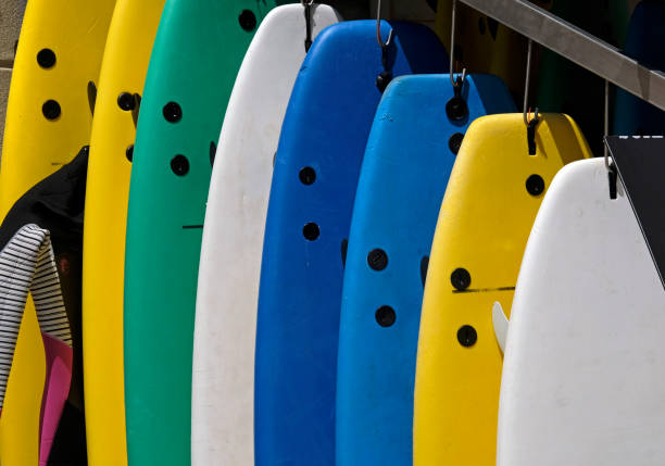 istock Multiple colorful surfboards hanging in front of a house 1498133707