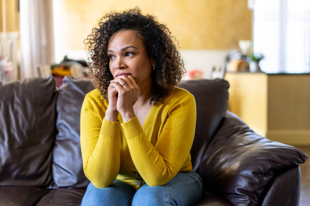 istock Depressed upset young woman sitting alone at home 1498134480
