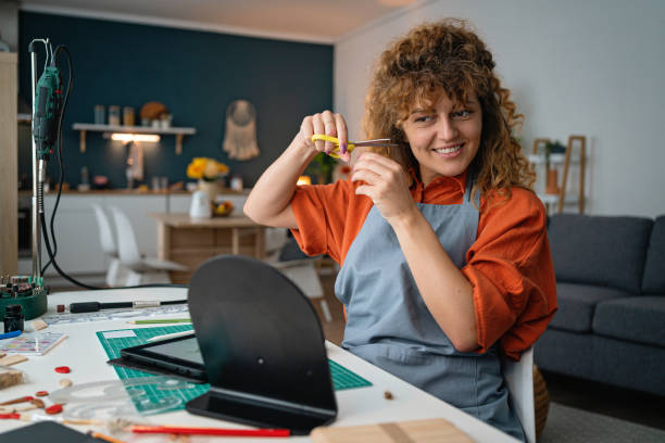 istock At the workshop, female artist cutting her hair, while taking break from work 1498135250