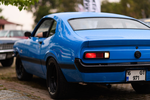 Izmir, Turkey - June 3, 2023: Rear view of a blue 1971 Maverick on a rainy day