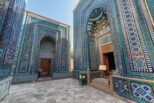 Awesome view of the upper group of mausoleums at the Shah-i-Zinda Ensemble in Samarkand, Uzbekistan. Mausoleums decorated by blue tiles with designs are a popular tourist attraction of Central Asia.