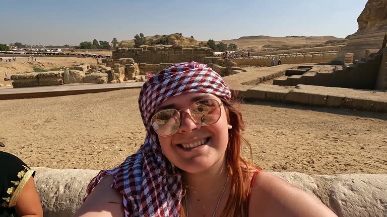 Young Woman Having A Video Call In Front Of The Great Sphinx Of Giza In Cairo