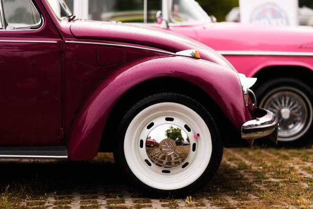 Izmir, Turkey - June 3, 2023: Close-up of raindrops on the right front fender of a pink 1972 Volkswagen Beetle at the IZKOD Classic Car Meet at Buca Pond in Izmir