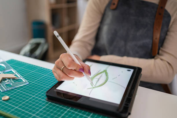 istock Unrecognizable female artist making a sketch design on iPad 1498140012