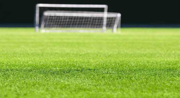 istock soccer field green grass with a background arch with maya 1498141436
