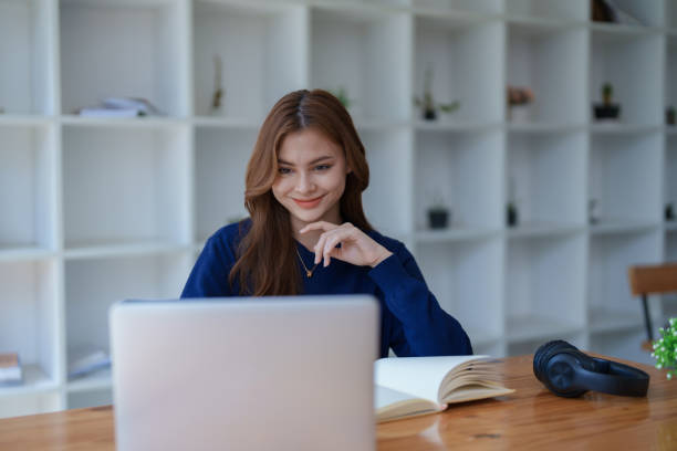 istock Happy latin girl college student watching distance online learning class, remote university webinar or having talk on laptop video call and use notebook to virtual meeting seminar at home or campus. 1498142392
