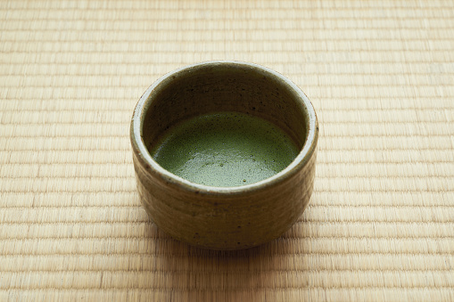 apanese traditional matcha tea on tatami background