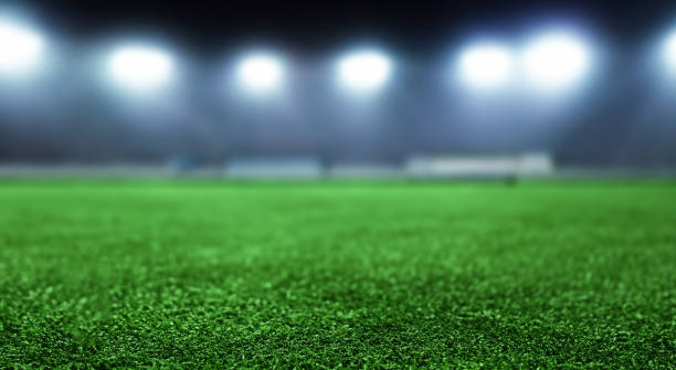 istock beautiful soccer field grass with defocused background with bokeh lights 1498146984