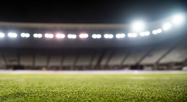 istock beautiful soccer field grass with defocused stands 1498147000