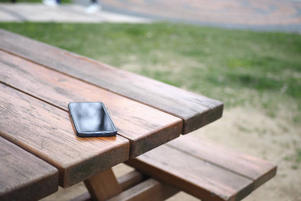 istock forget smartphone on a park bench, lost smart phone 1498147840