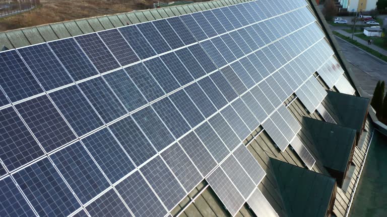 Solar panels installed on the roof of the building, drone view.