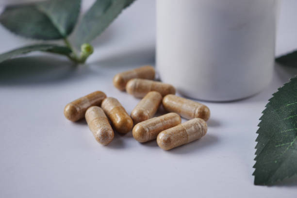 istock herbal medicine capsule and a container on white 1498150903