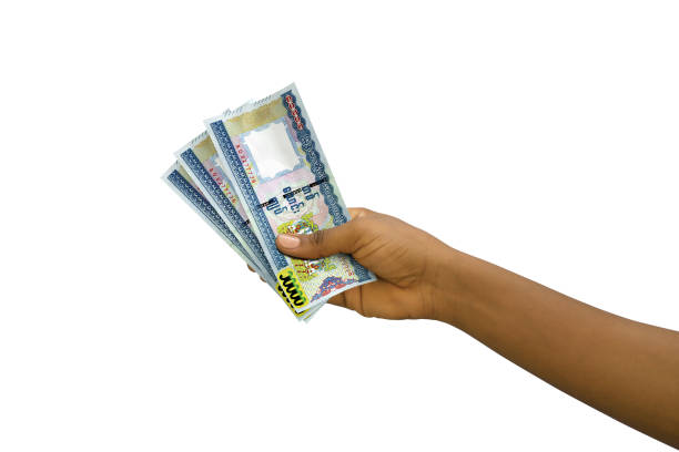 istock Fair hand holding 3D rendered Myanmar kyat notes isolated on white background 1498151341