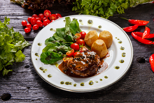 Filet mignon steak with arugula, cherry tomatoes, potatoes