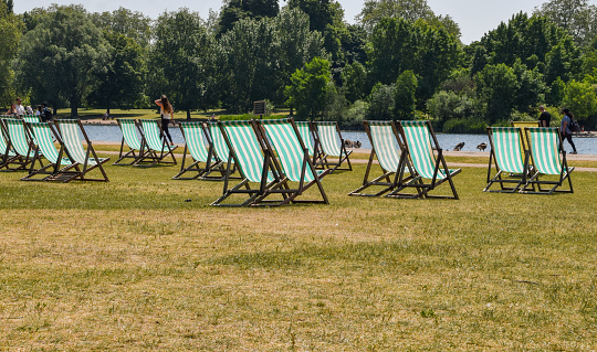 London, UK - June 9 2023: Deckchairs in Hyde Park on a hot day