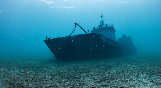 istock destroyed ship under the deep sea on the dirty sand 1498154170