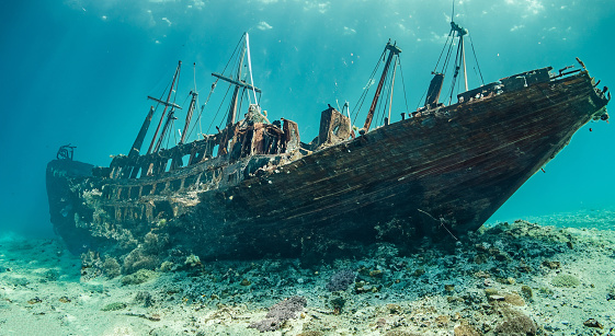 amazing rusty ship sunk in the middle of the sea with good day lighting in the crystal blue pacific sea