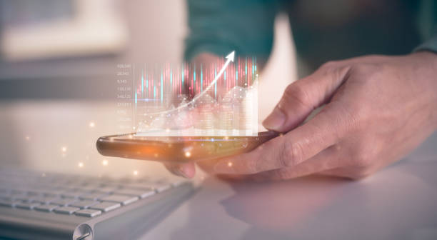 istock financial investment concept, businessman using smartphone and keyboard  touching virtual trading graph buy and sell share in concept of investment business growth and marketing 1498156312