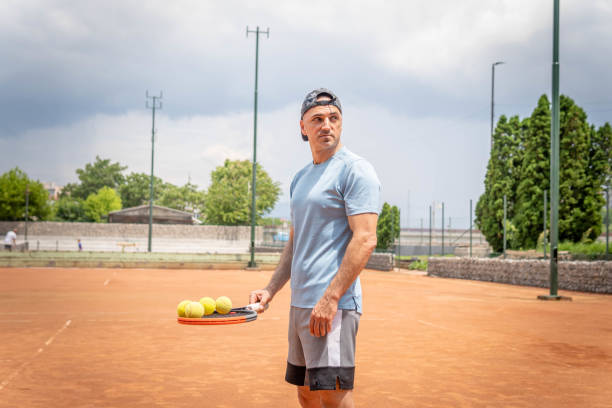 istock Male tennis player training on court 1498157920