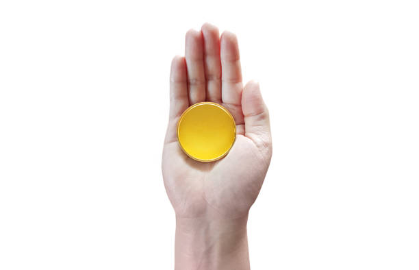 istock gold coin in hand isolated on white background 1498158829