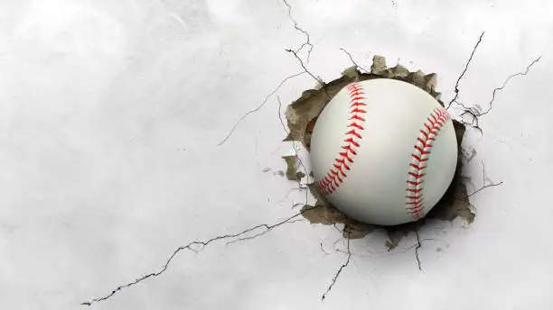 Photo of A baseball hits through a cement wall. concept of strength