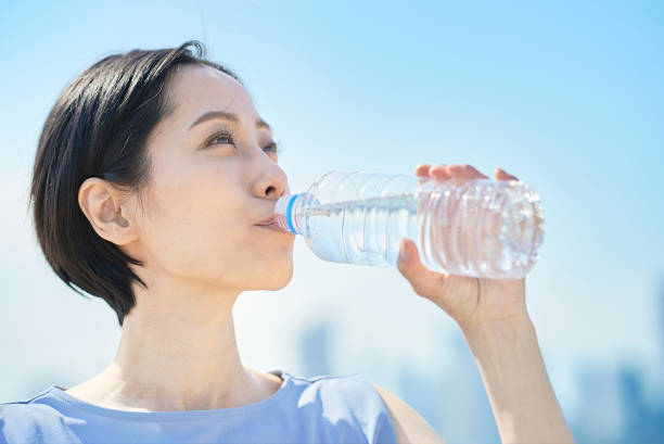 istock Woman drinking water from a plastic bottle 1498159580