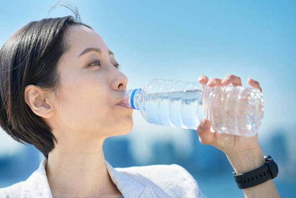 istock Woman drinking water from a plastic bottle 1498159718