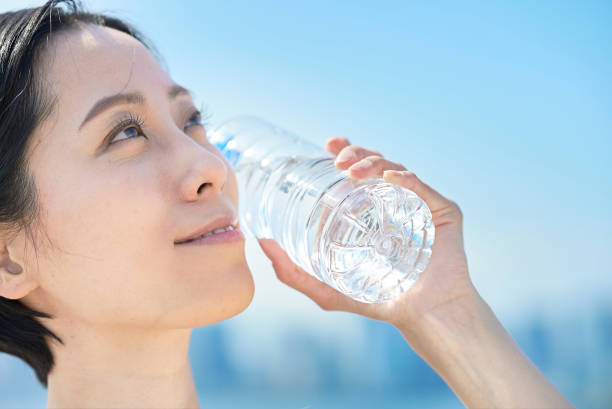 istock Woman drinking water from a plastic bottle 1498159880