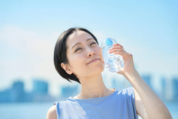 istock Woman drinking water from a plastic bottle 1498159933