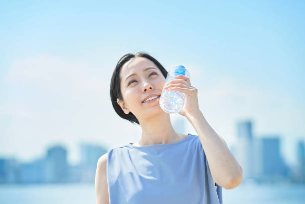 istock Woman drinking water from a plastic bottle 1498159964