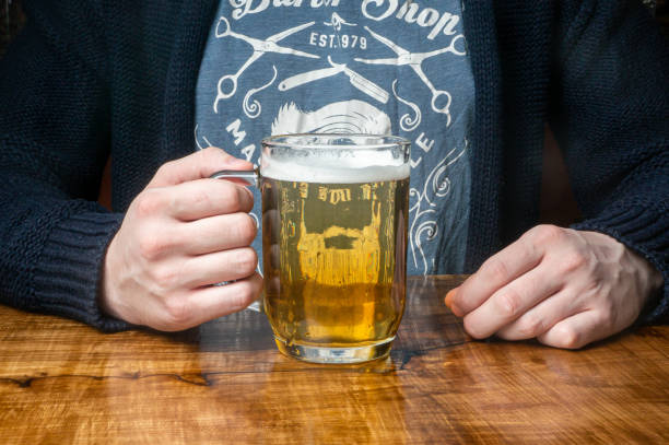 istock a mug filled with beer in your hands 1498159968