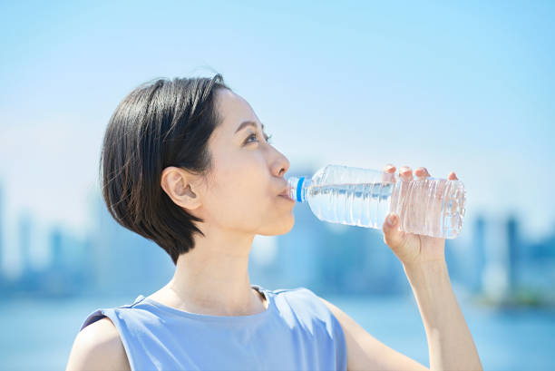 istock Woman drinking water from a plastic bottle 1498160045