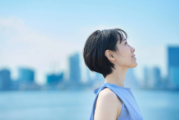 istock A woman with a relaxed expression under the blue sky 1498160094