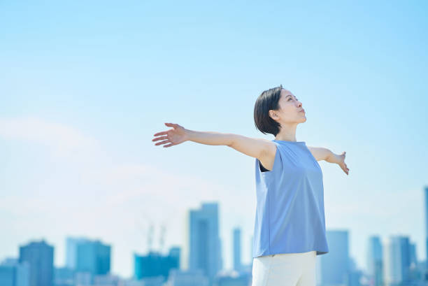 A woman with a relaxed expression under the blue sky
